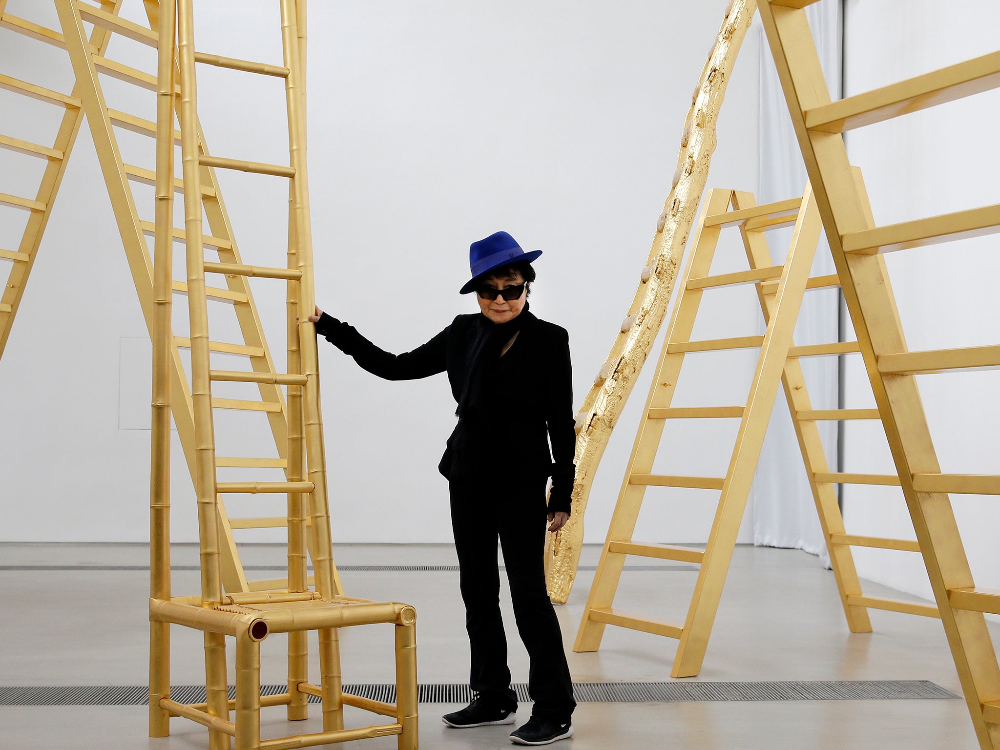 Yoko Ono poses with her art installation "Golden Ladders" on display at her exhibition held at the 798 art district in Beijing, China
