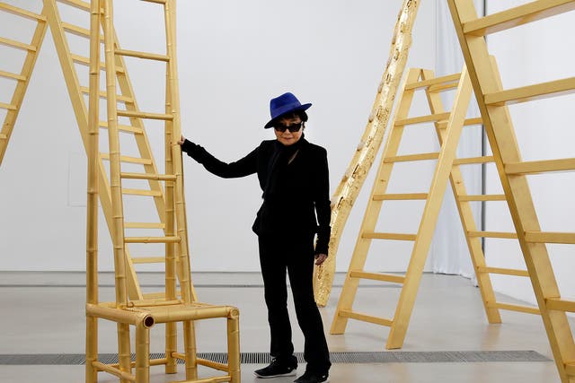 Yoko Ono poses with her art installation "Golden Ladders" on display at her exhibition held at the 798 art district in Beijing, China