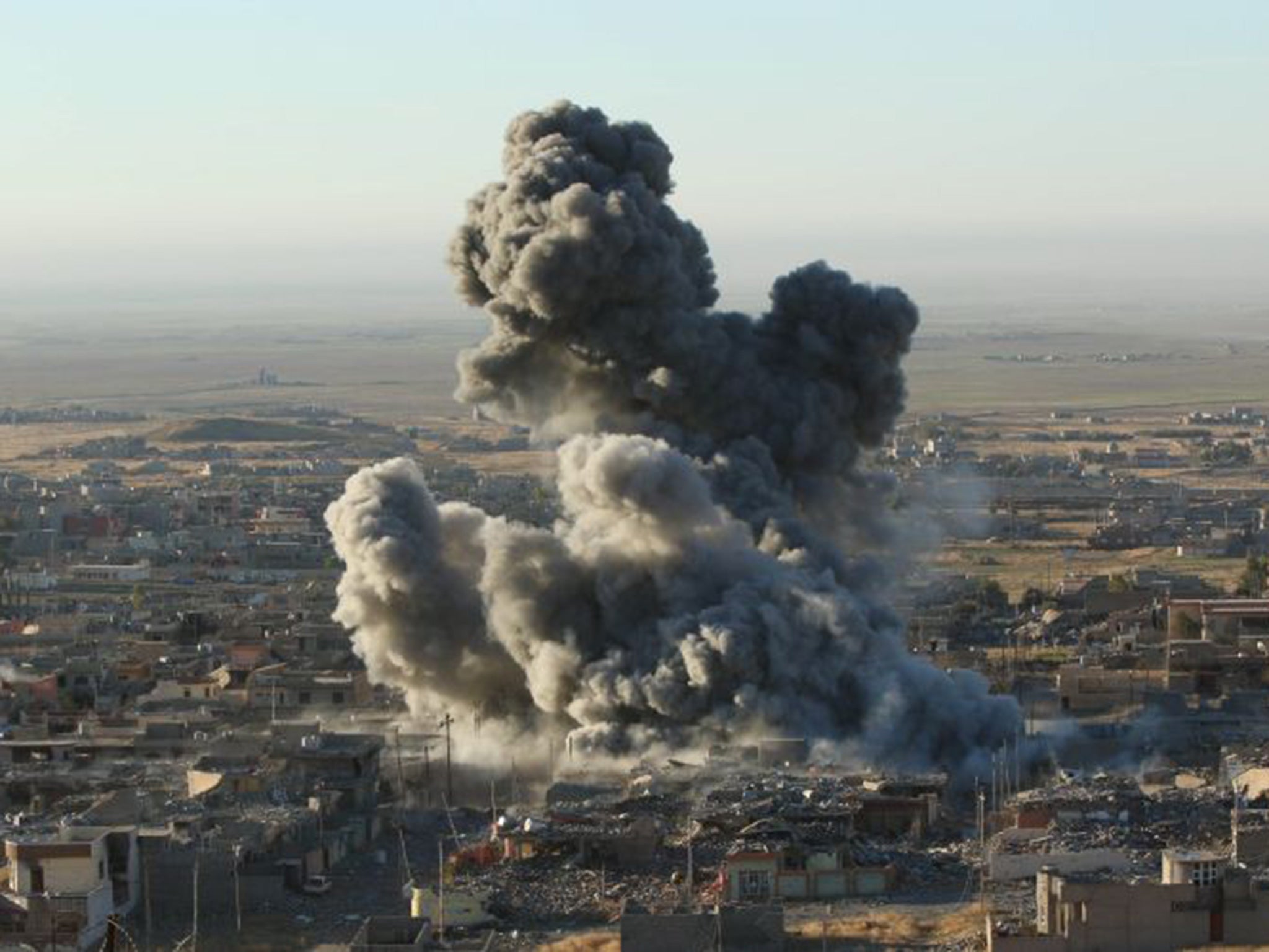 Smoke rises from the site of U.S.-led air strikes in Sinjar earlier over the weekend