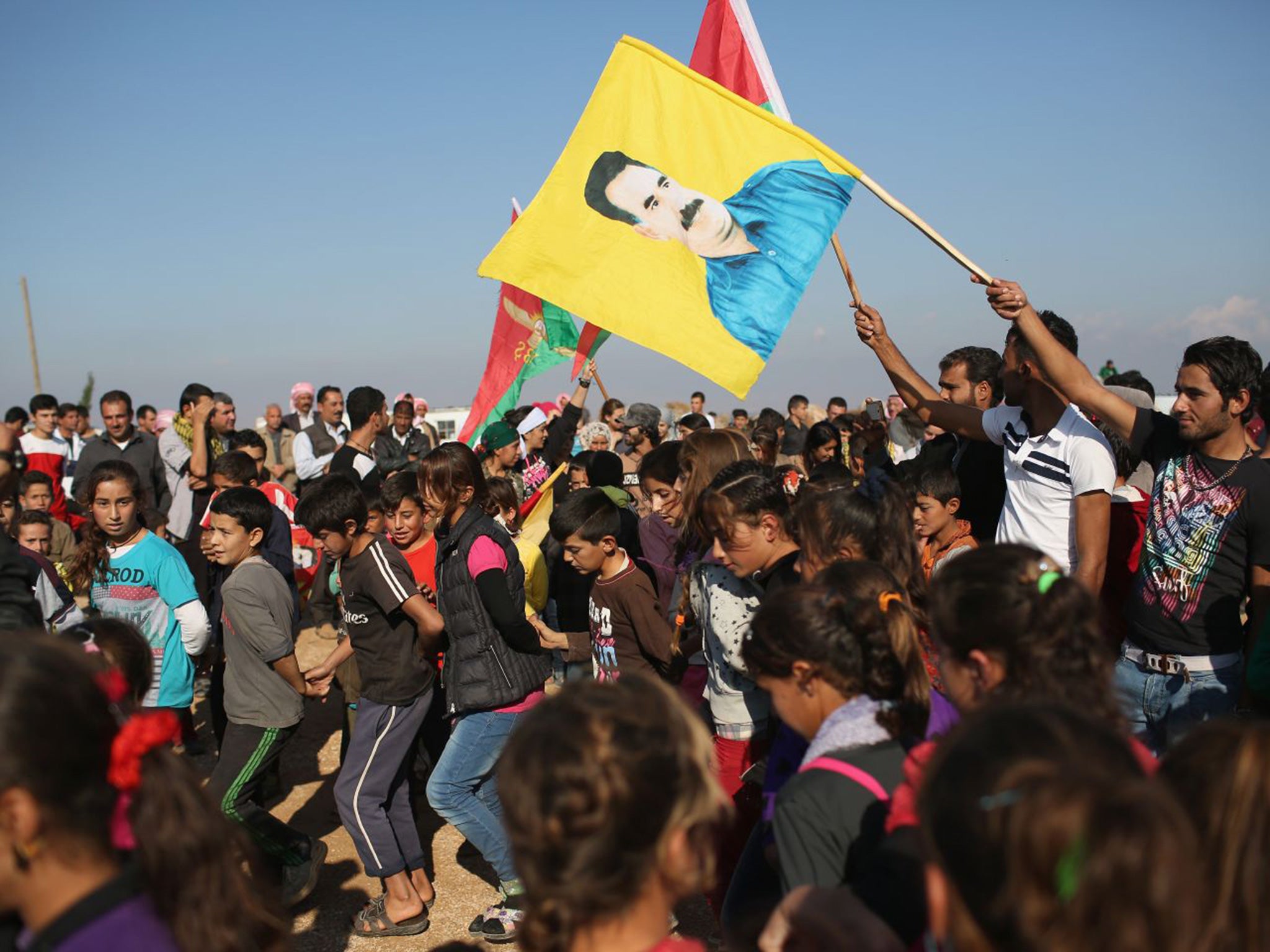 Yazidi refugees celebrate news of the liberation of their homeland of Sinjar