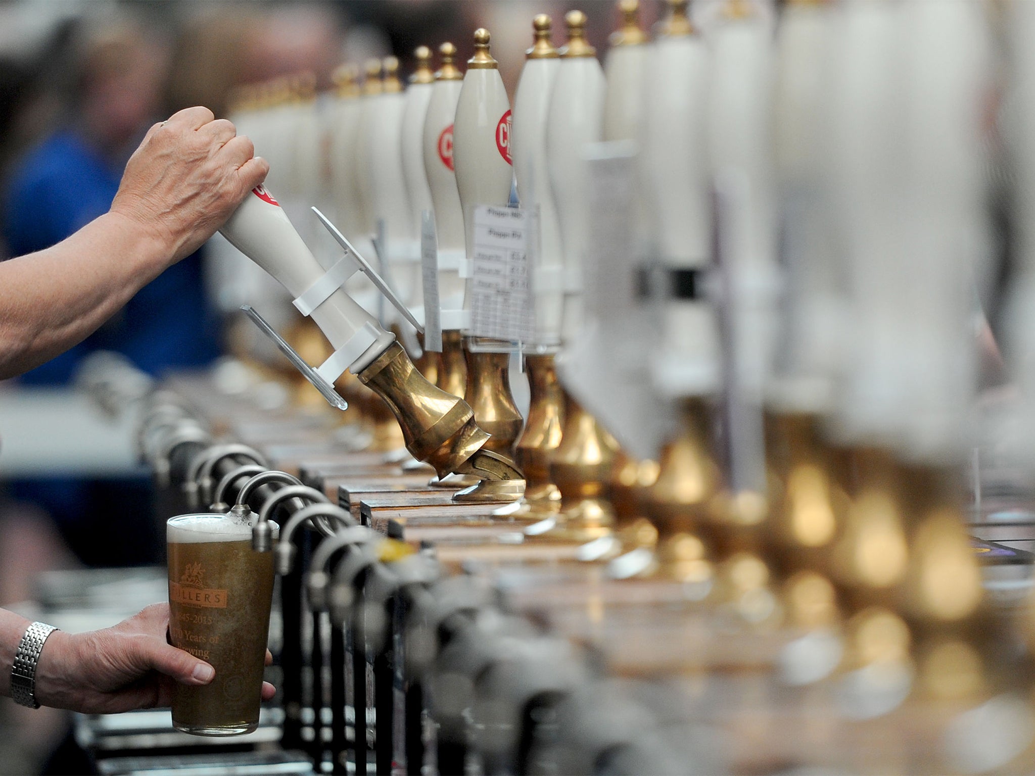 A drink is poured during the annual Great British Beer Festival organised by the Campaign for Real Ale (CAMRA) at Olympia in London