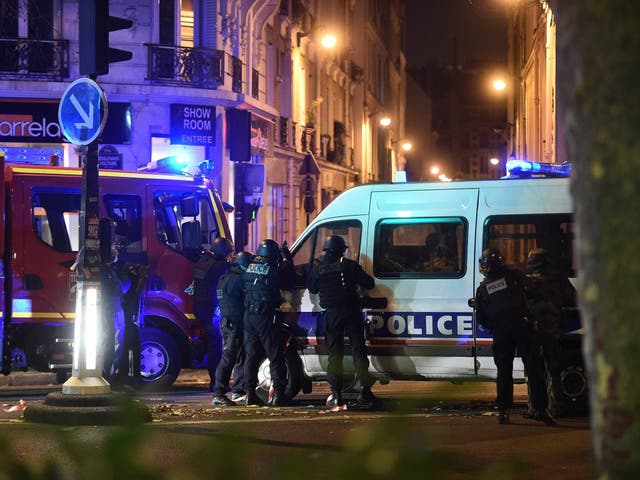 Police officers gather outside the Bataclan concert venue