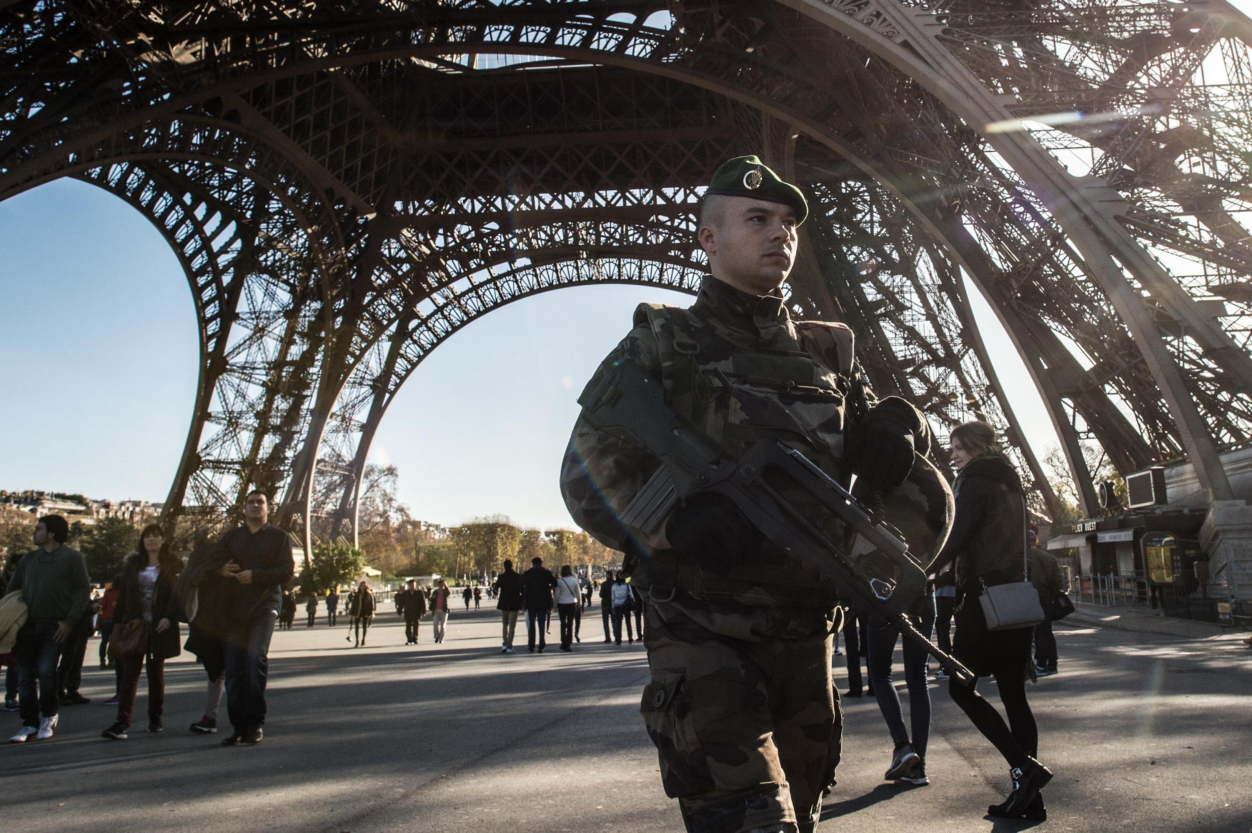 A French soldier stands guard at the Eiffel Tower