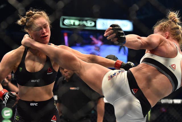 Holly Holm (right) delivers the stunning kick to floor Ronda Rousey