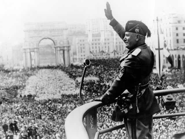 Benito Mussolini saluting during a public address