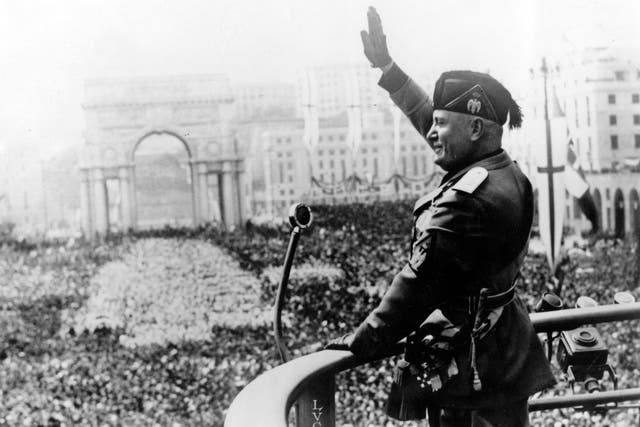 Benito Mussolini saluting during a public address