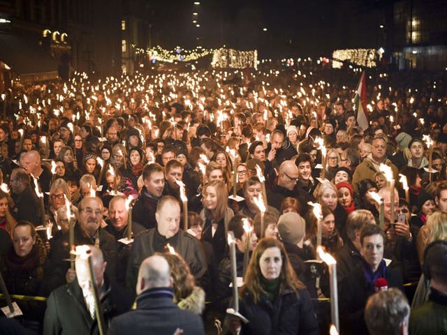 People attend a vigil for Paris attack victims in front of the French Embassy on November 15, 2015 in Copenhagen