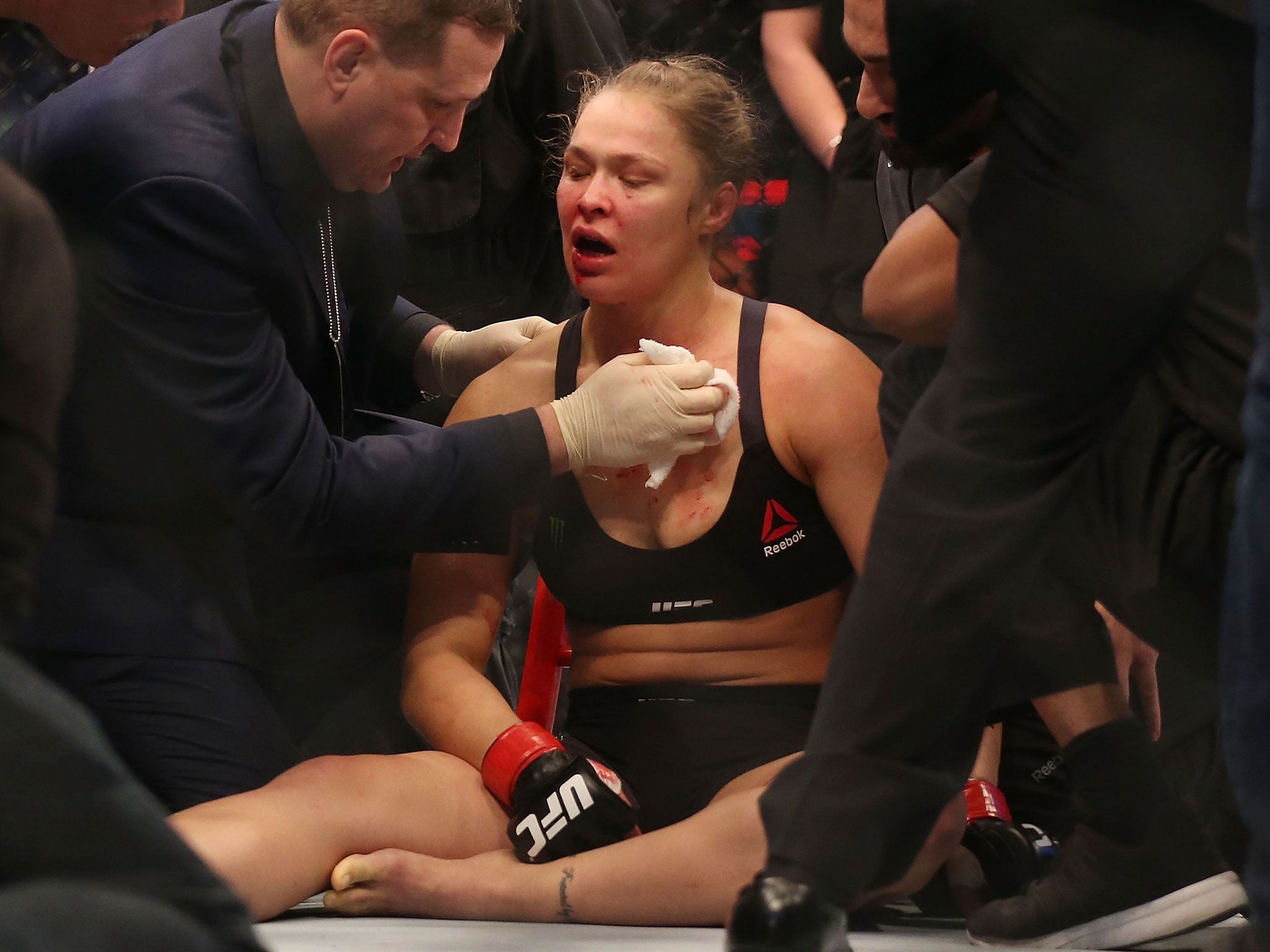 Ronda Rousey is treated after being knocked out by Holly Holm