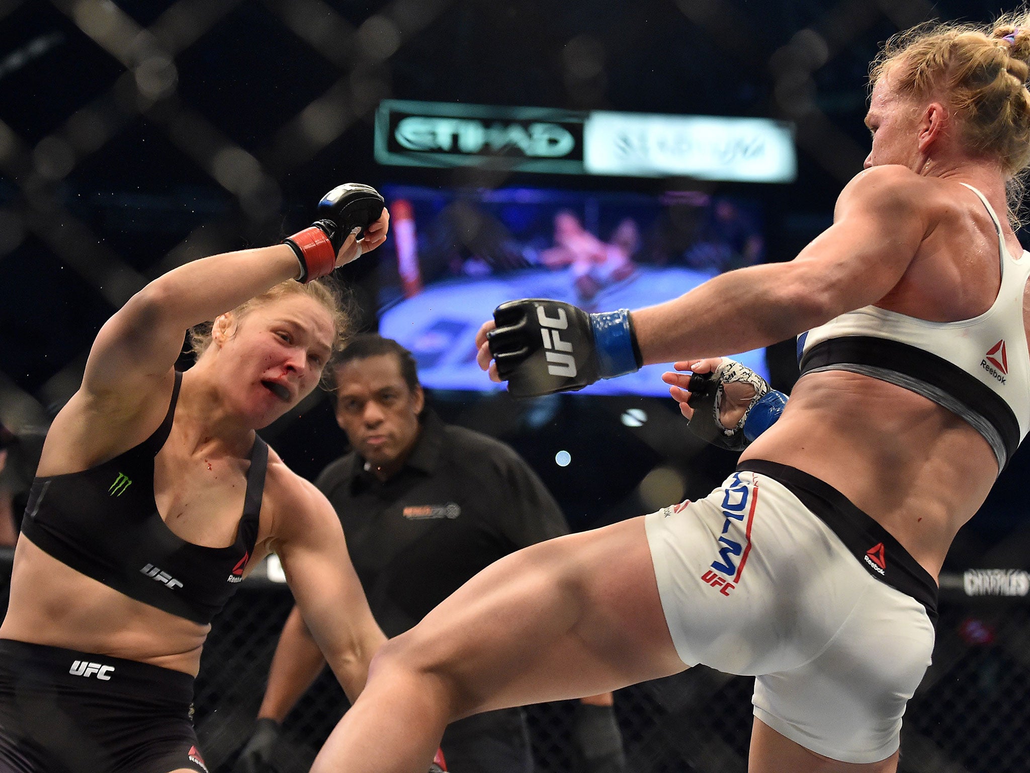 Rousey is rocked as Holm delivers a knockout kick to win the UFC bantamweight title
