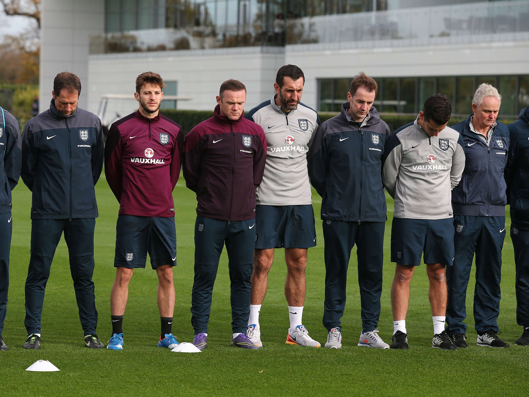 England players and coaches observe a minute of silence in tribute to victims of the November 13 Paris attacks during a team training session at Tottenham Hotspur Training Centre in London