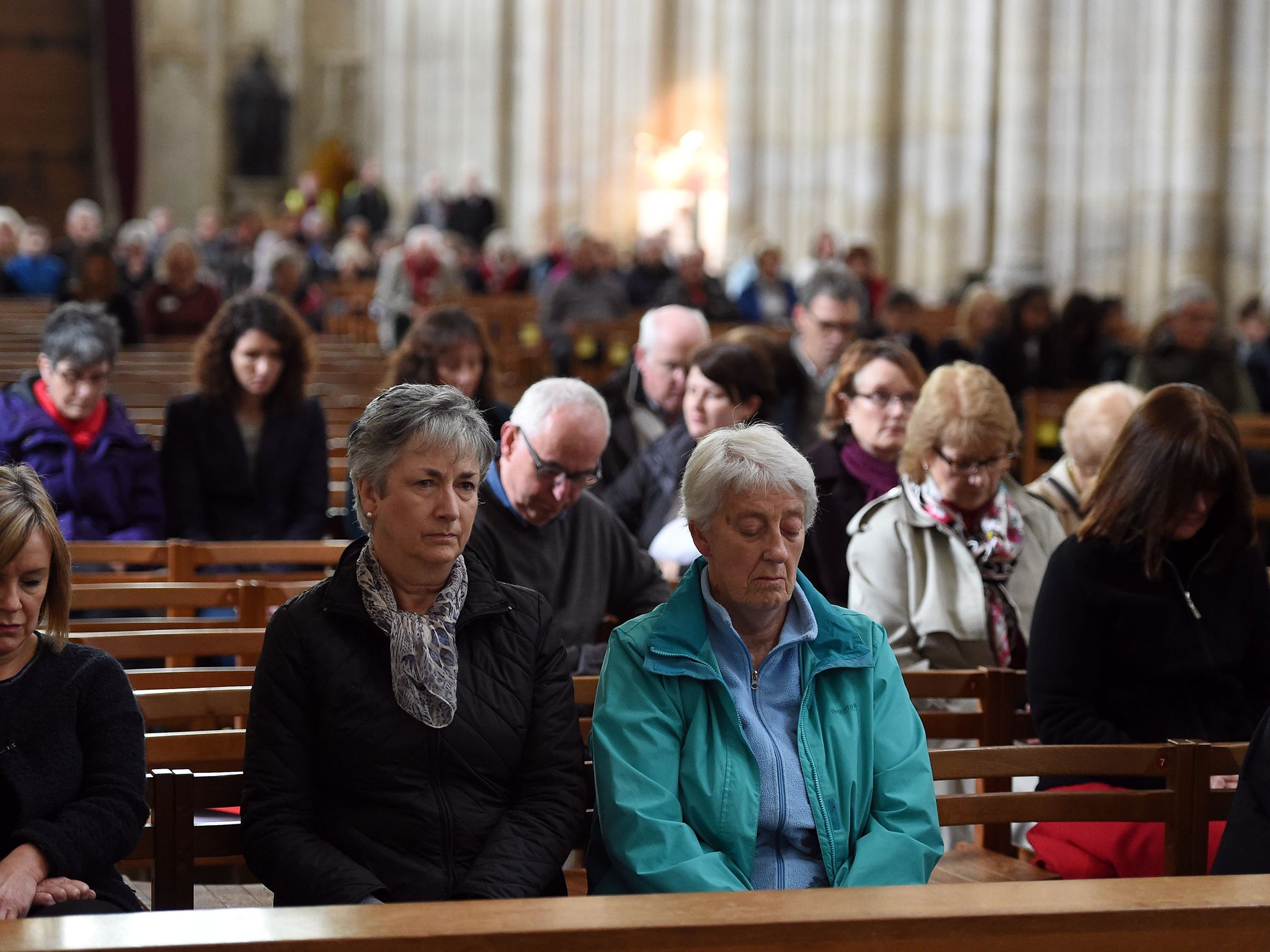 People inside Winchester Cathedral, Hampshire, during a minute's silence to mark the victims of the attacks in the French capital