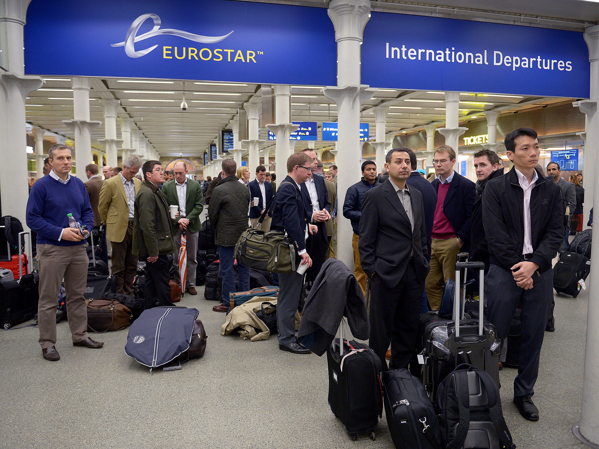 Passengers at St Pancras International Station in London during a minute's silence across Europe to mark the victims of the attacks in the French capital