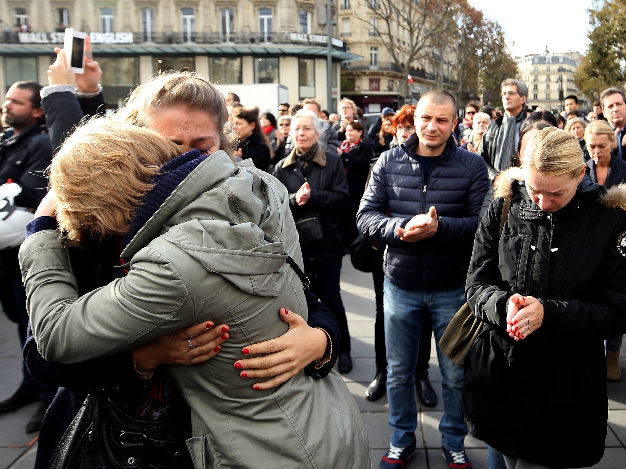 Crowds gather in the Place de la Republique, Paris, to observe a minute's silence across Europe to mark the victims of the attacks in the French capital