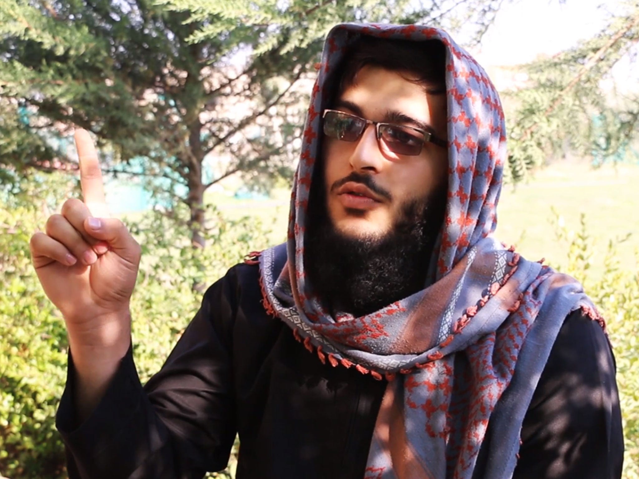 One Isis militant gestures during the video threatening attacks on the West