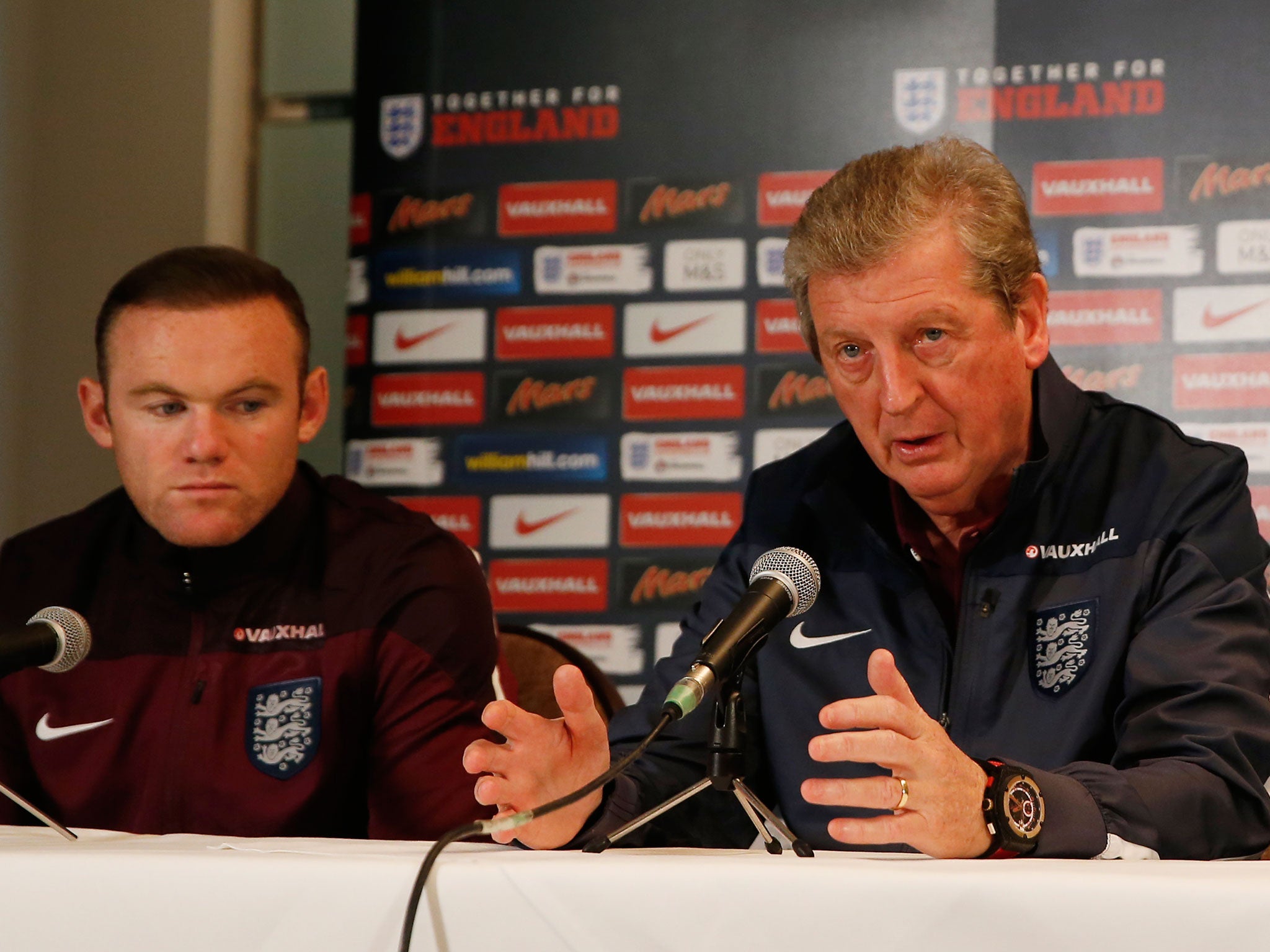 Roy Hodgson (R) and Wayne Rooney express their condolences to the victims of the Paris attacks