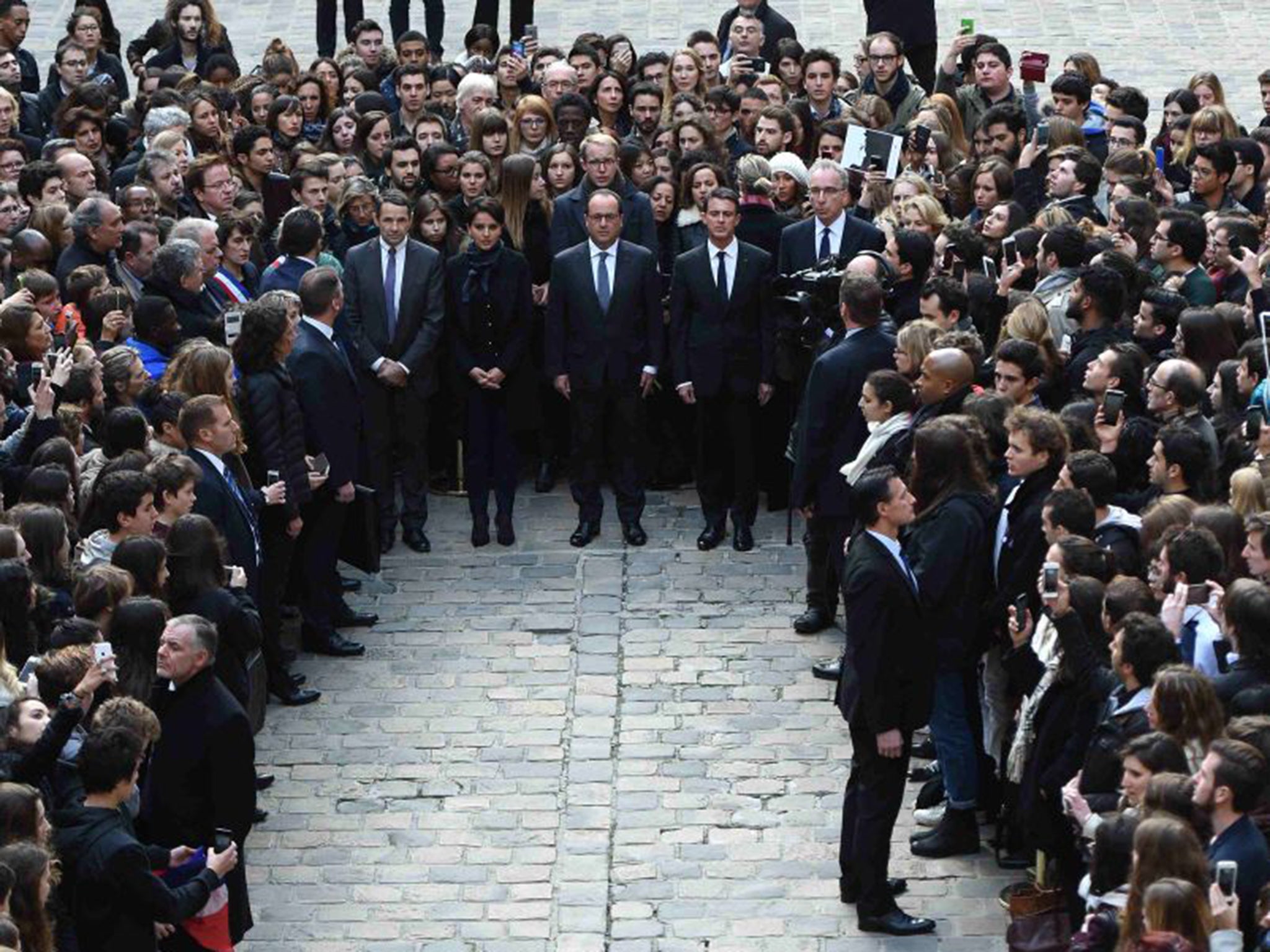 From left: French Minister for Higher Education and Research, Thierry Mandon; French Education Minister, Najat Vallaud-Belkacem; French President, Francois Hollande; and French Prime Minister, Manuel Valls stand among students as they observe a minute of silence at the Sorbonne University in Paris
