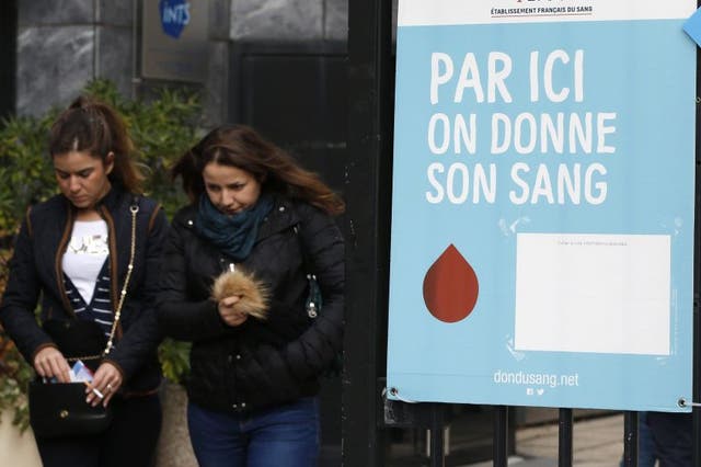Two women leaving a blood donation centre in Paris in the wake of the attacks