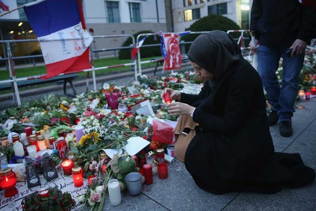A woman pays tribute to the victims of the Paris attack