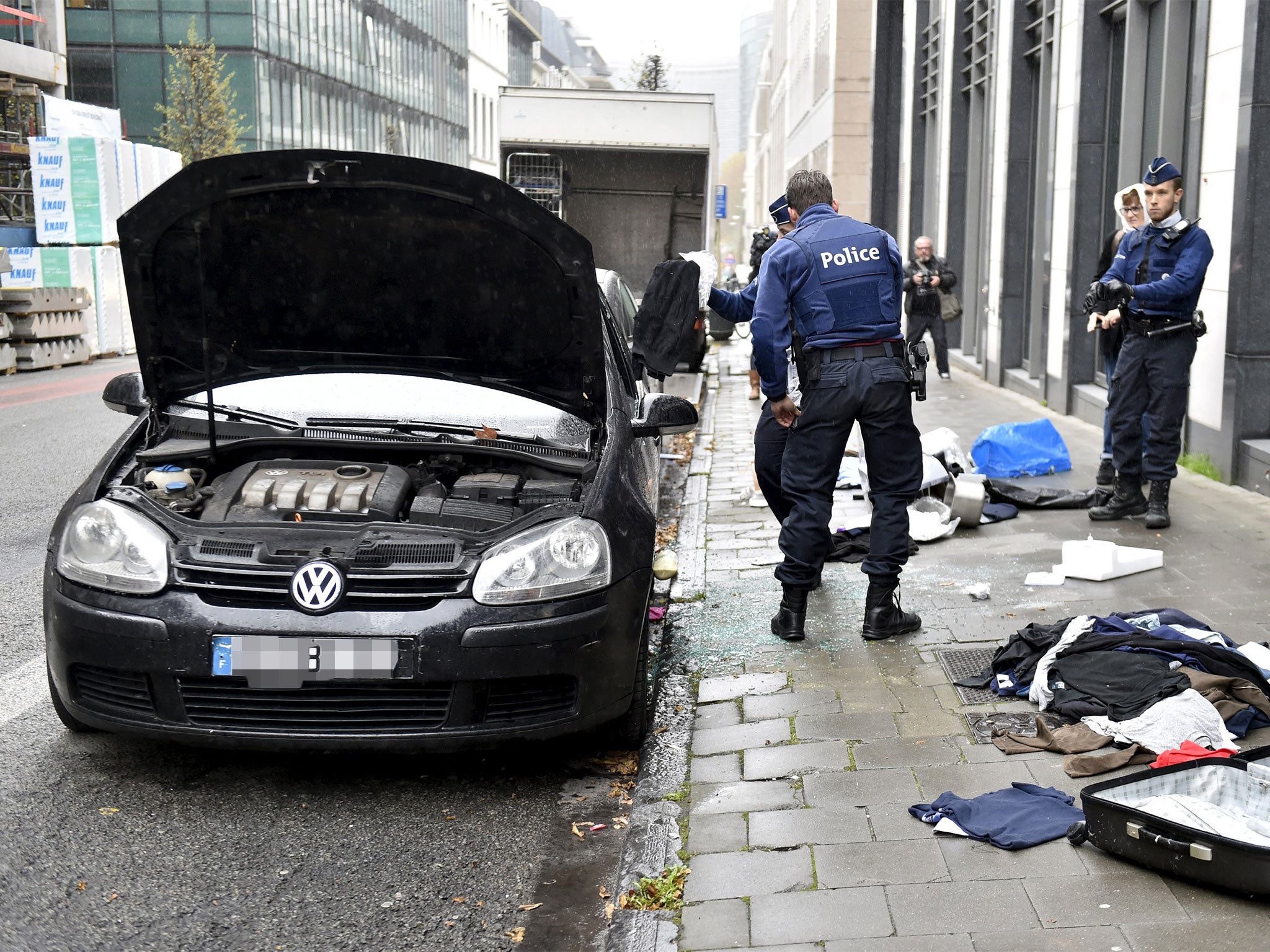Belgian police search a car during raids in Brussels