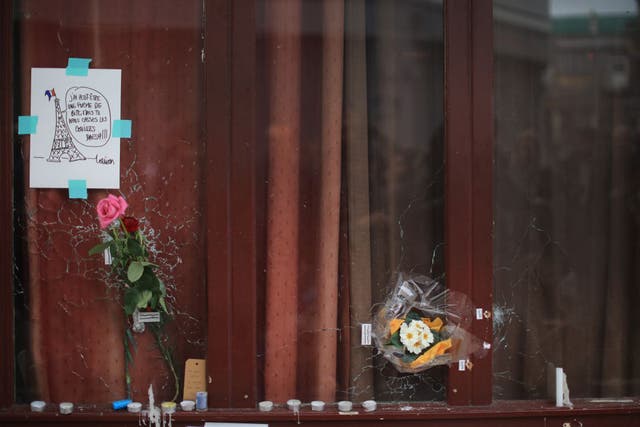 Flowers and tributes adorn the bullet damaged windows of the Le Carillon restaurant, one of the scenes of the November 16 attacks in Paris