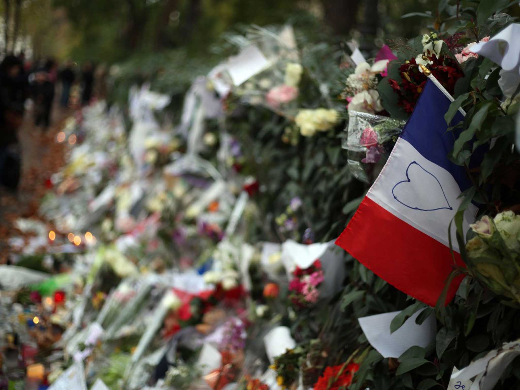 People leave tributes to the victims of the Paris attacks