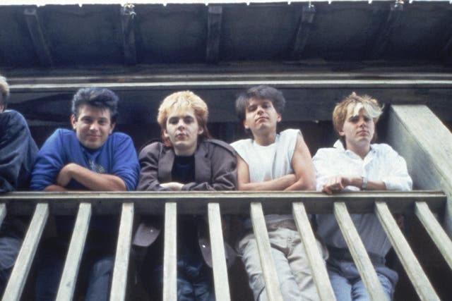 Duran Duran posing on a balcony