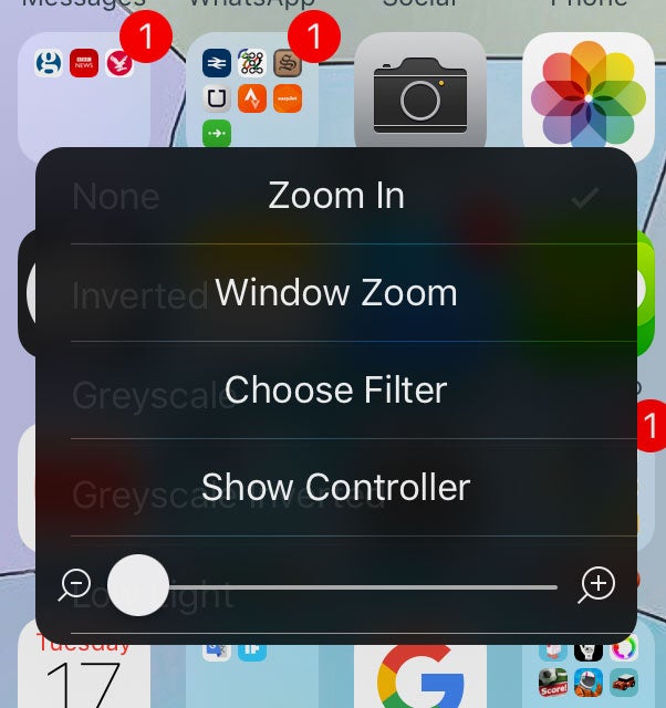 Once zoom is turned on, tapping three times with three finger will bring up this menu, allowing you to choose the 'low light' filter that turns your screen's brightness right down