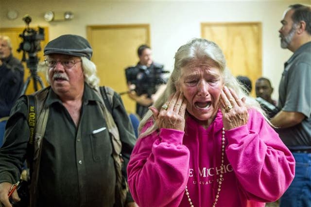 Flint resident Gladyes Williamson cries as lawsuit is filed