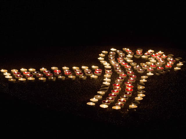 Candles in the shape of the AIDS ribbon