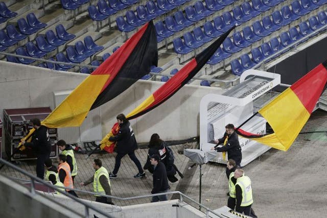 German flags are carried out of the Hannover stadium as the soccer friendly between Germany and the Netherlands was cancelled