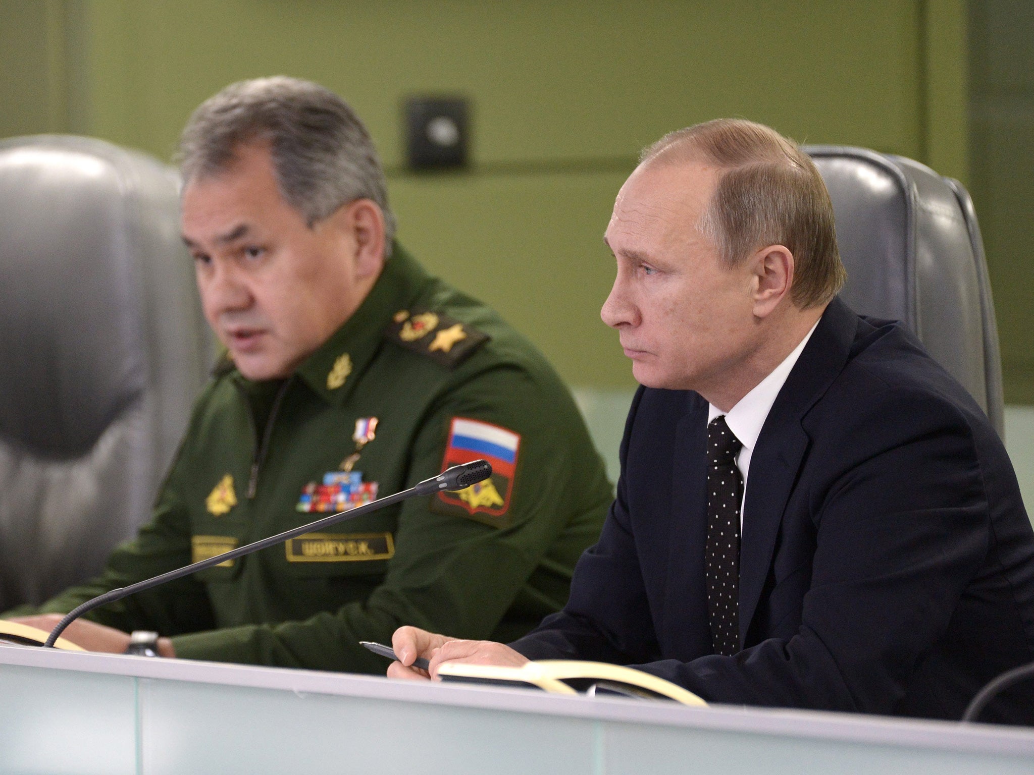 Russian President Vladimir Putin, right, and Defense Minister Sergei Shoigu touring the National Defense Management Center in Moscow