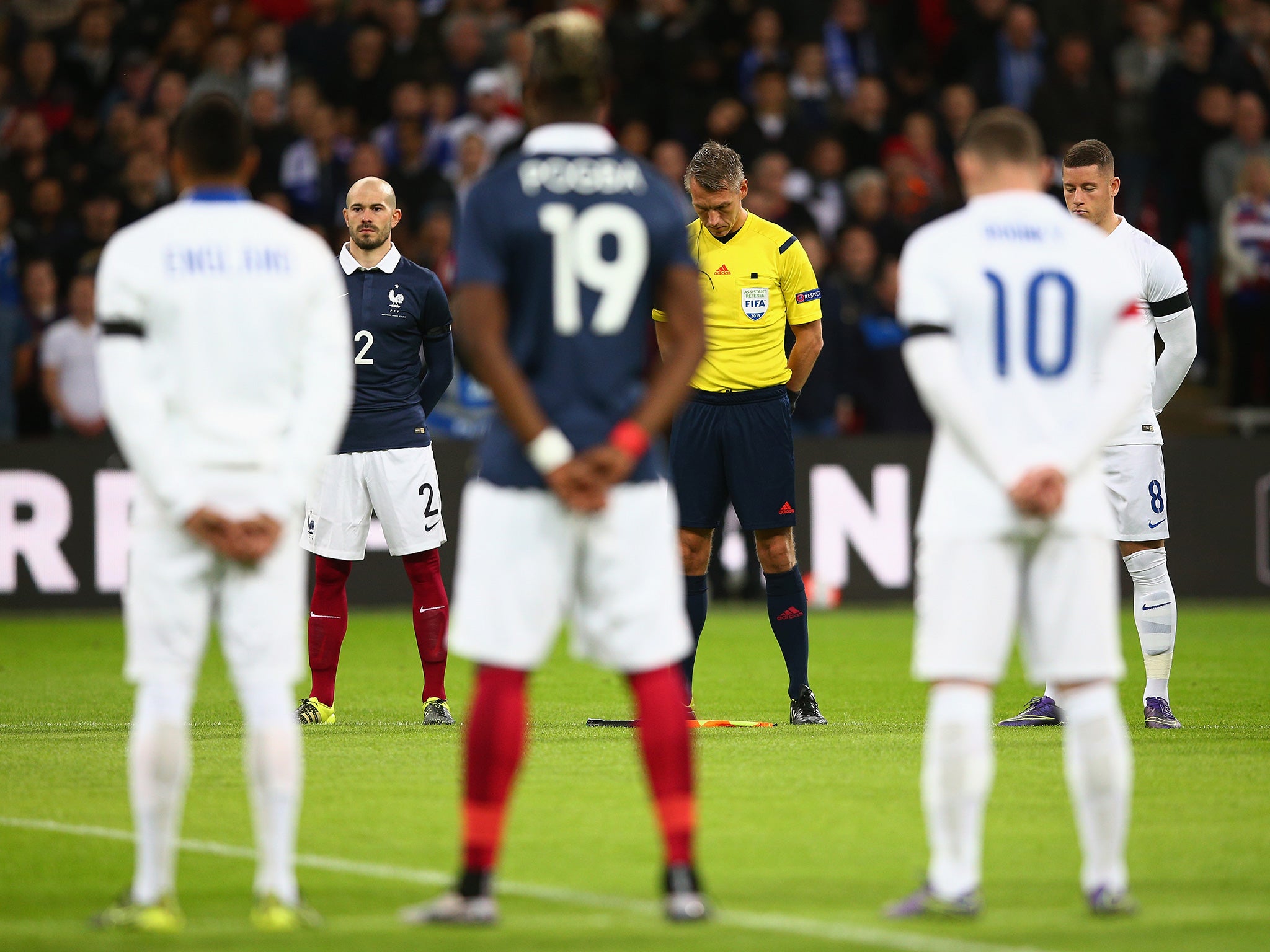 Players and match officials observe a minute of silence to remember the those lost their lives in the recent terror attack in Paris prior to the International Friendly match between England and France at Wembley Stadium