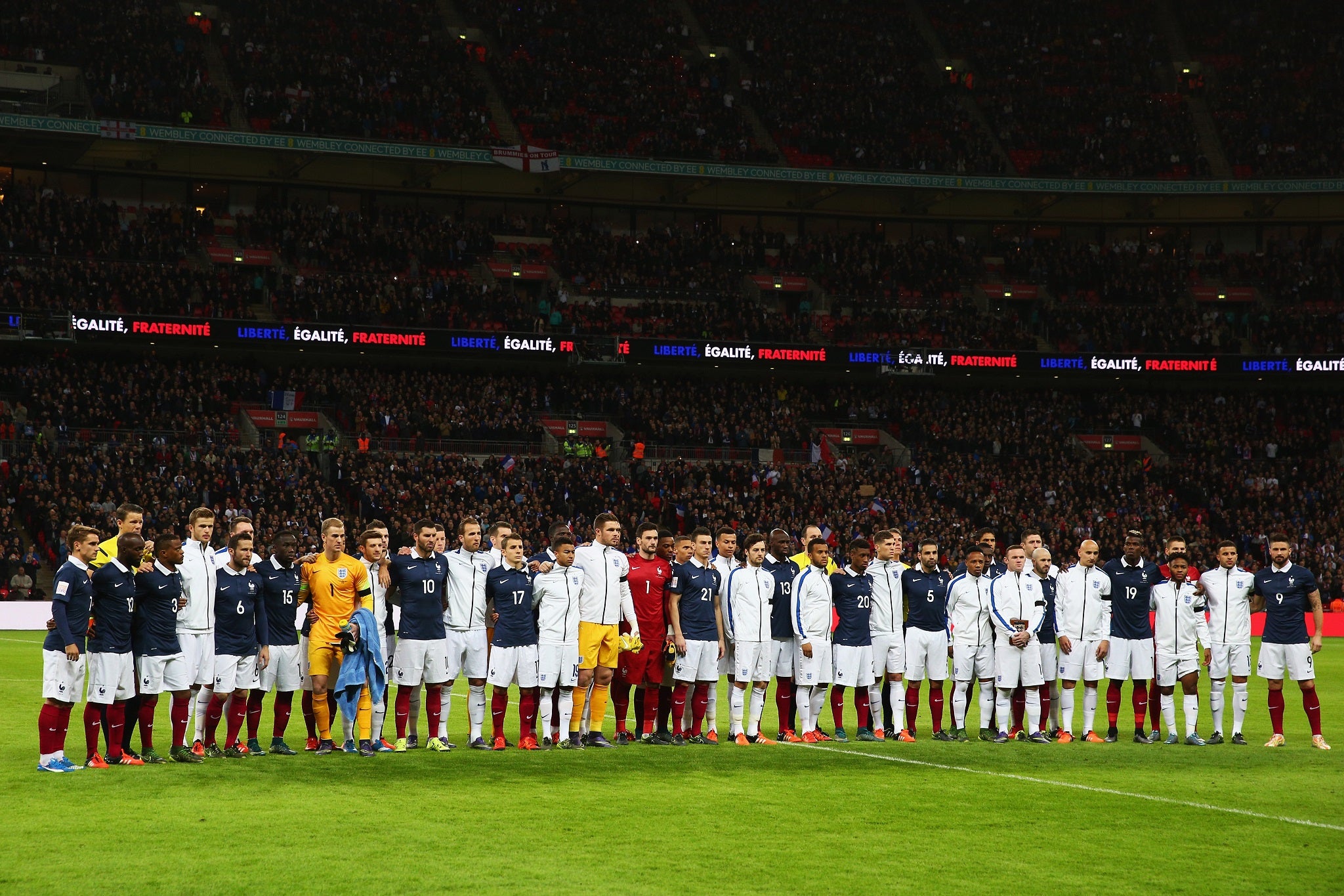 England and France players line up together before a minute's silence for the victims of the Paris terror attacks