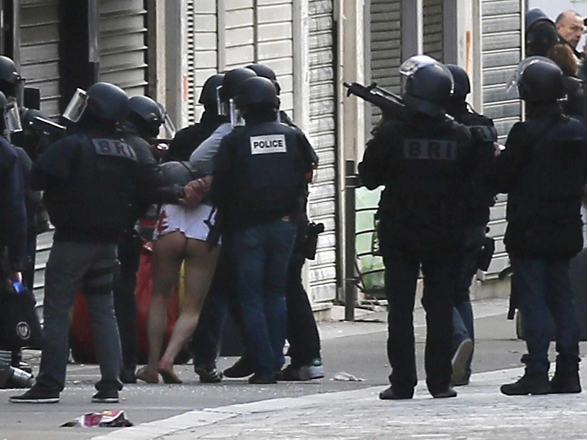 A man is arrested by police officers at the site were a raid happened in the city center of Saint Denis, near Paris, France