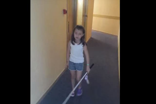 Lily-Grace using her cane in a video shot by her mother Kirsty