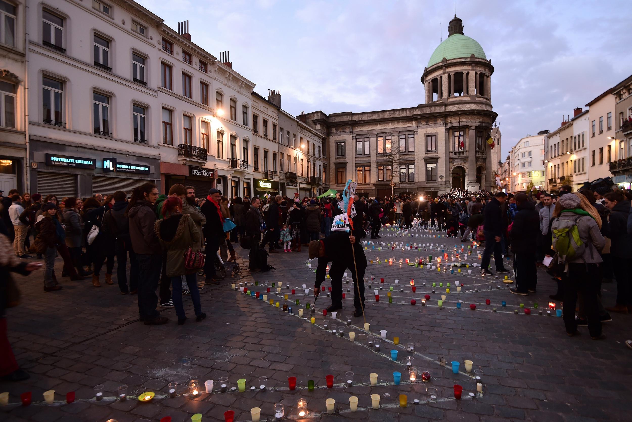 People take part in a candlelight vigil in the main square of Molenbeek, Brussels