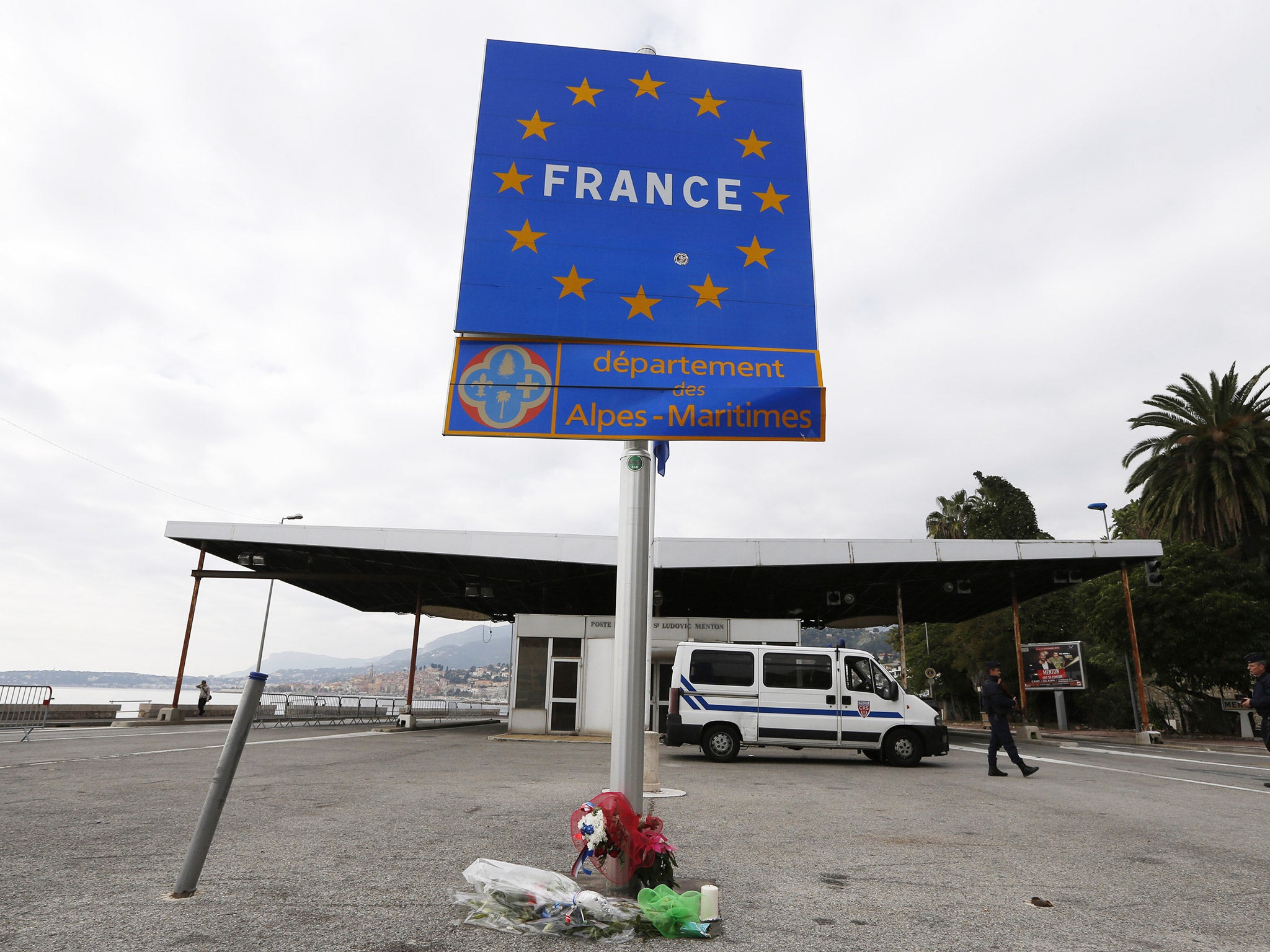 French police stand at the Franco-Italian border in Menton, south eastern France