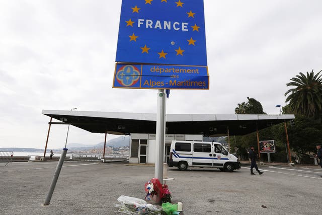 French police stand at the Franco-Italian border in Menton, south eastern France