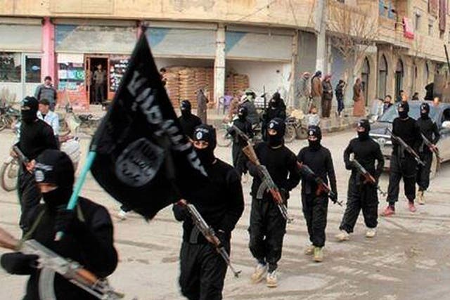 Isis fighters marching in Raqqa, Syria