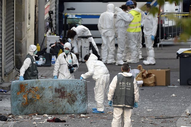 Forensic officers search for evidence following the raid on a building in Saint-Denis