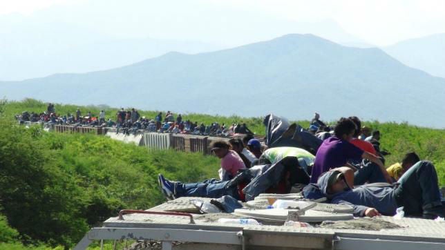 People hoping to reach the US ride atop a freight train, known as La Bestia - The Beast - in Ixtepec