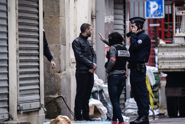 French police outside the Rue du Corbillon building in Saint-Denis