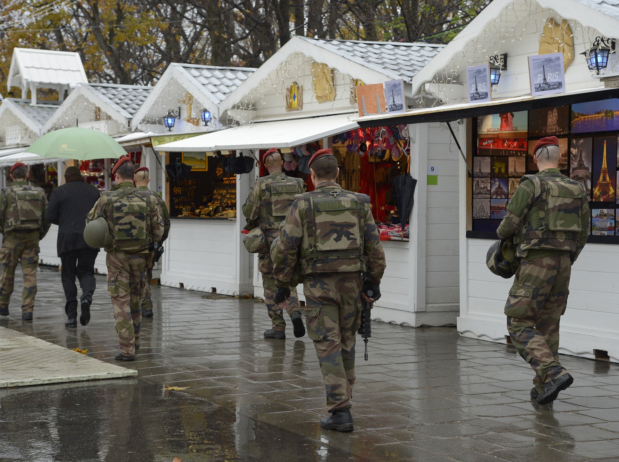 Caption:French soldiers patrol on the Champs-Elysees avenue on the reopening day of Paris' Christmas market, on November 19, 2015, as part of the security measures set following the November 13 attacks