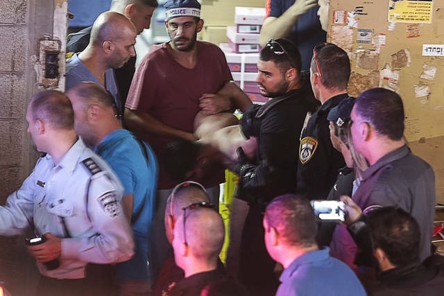 Israeli policemen arrest a Palestinian attacker at the scene of a stabbing attack in Tel Aviv, Israel. Two people were killed and a third injured by an assailant wielding a knife