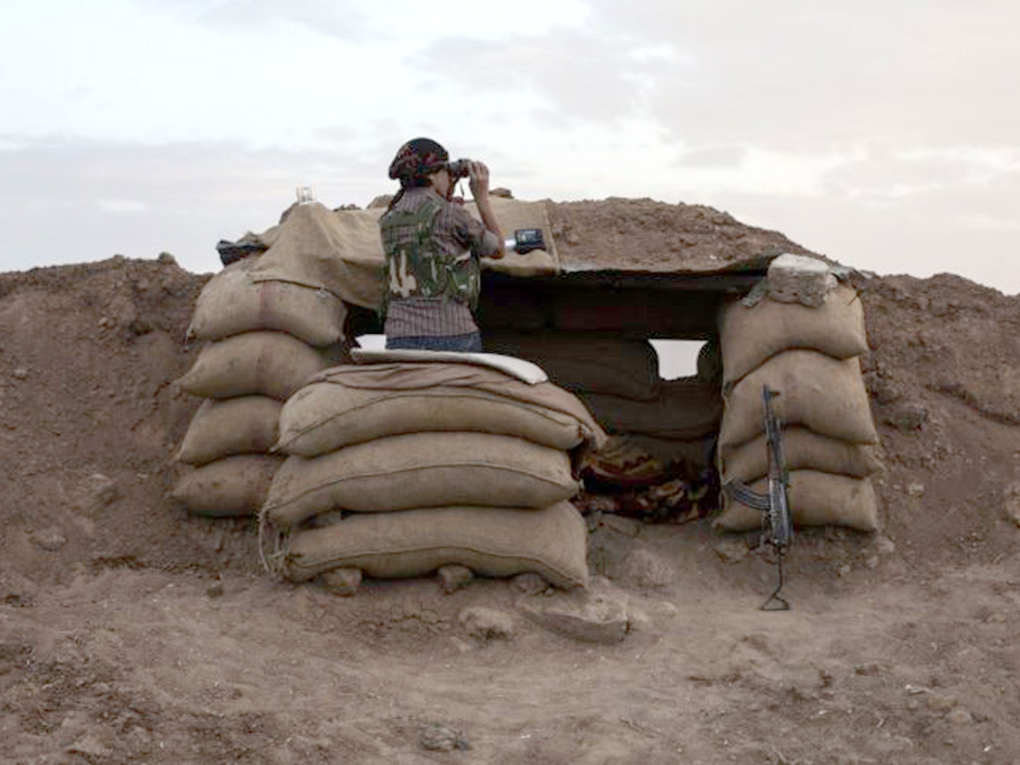 A Kurdish fighter surveys the border between Turkey and Iraq in early 2015