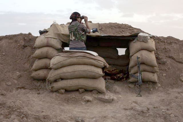 A Kurdish fighter surveys the border between Turkey and Iraq in early 2015