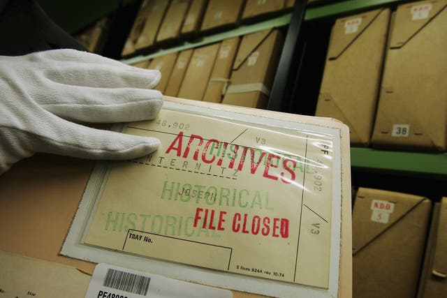 A member of staff removes a file from a depository at The National Archives. Many documents from the National Archives are available thanks to the Freedom of Information Act