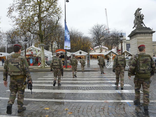 French policemen patrol on the Champs-Elysees avenue