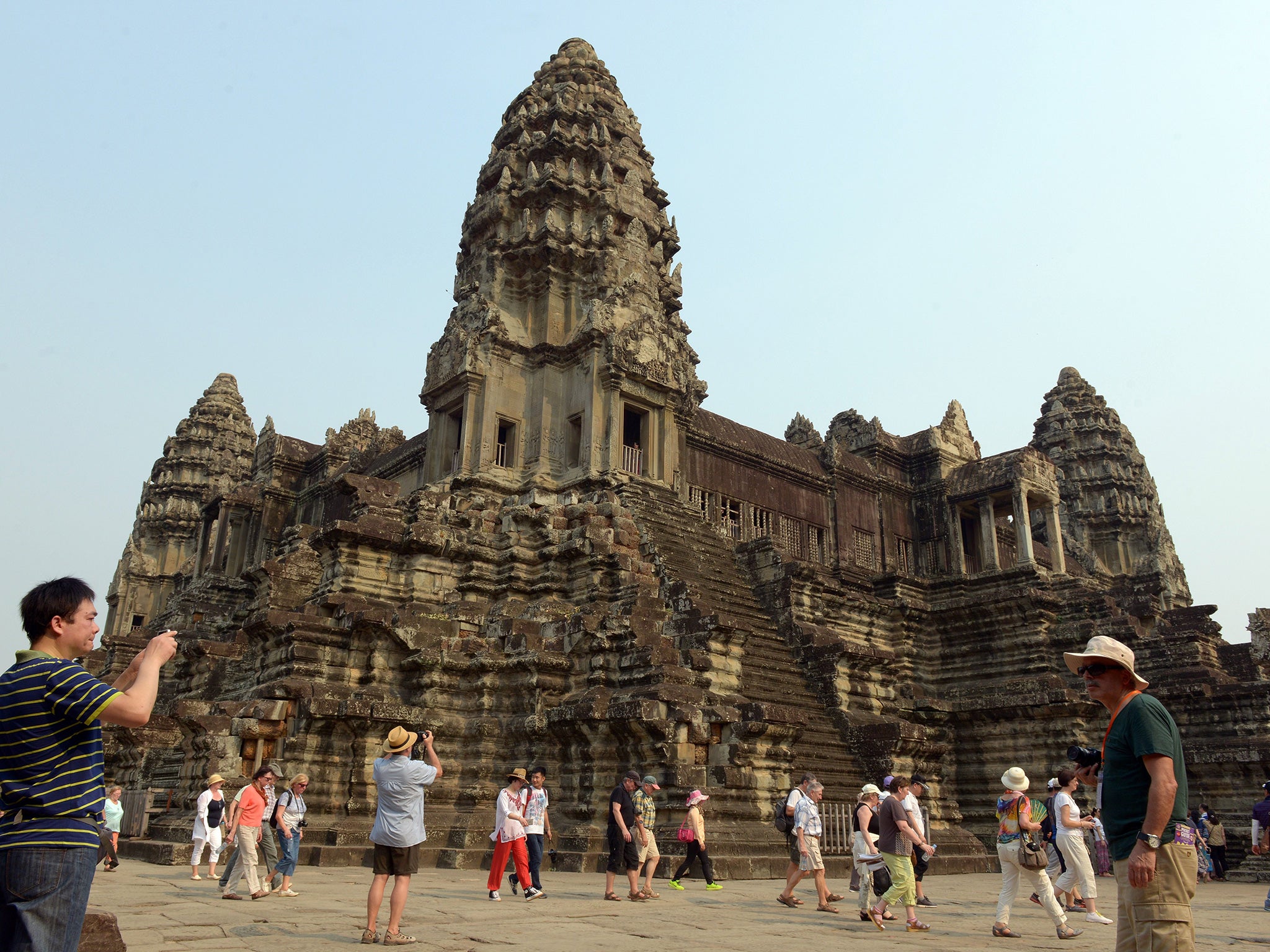 A tourist takes a photo of the Angkor Wat temple in the Siem Reap province of Cambodia