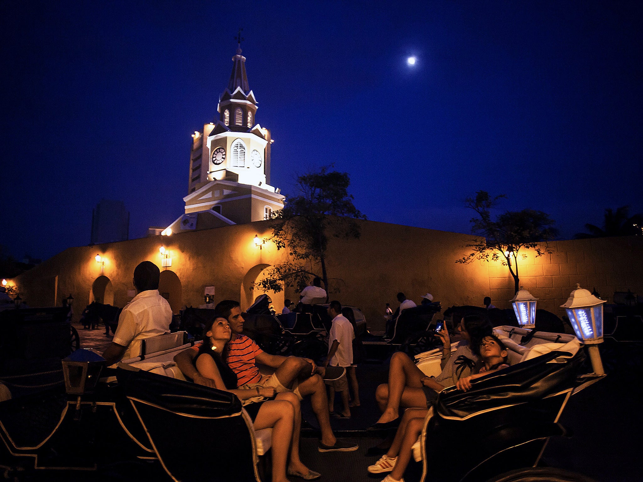 Tourists ride a horse-drawn carriage in the city of Cartagena